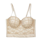 Beige bralette with pearl embellishments on a light blue background