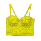 Yellow bralette with pearl embellishments on a white background