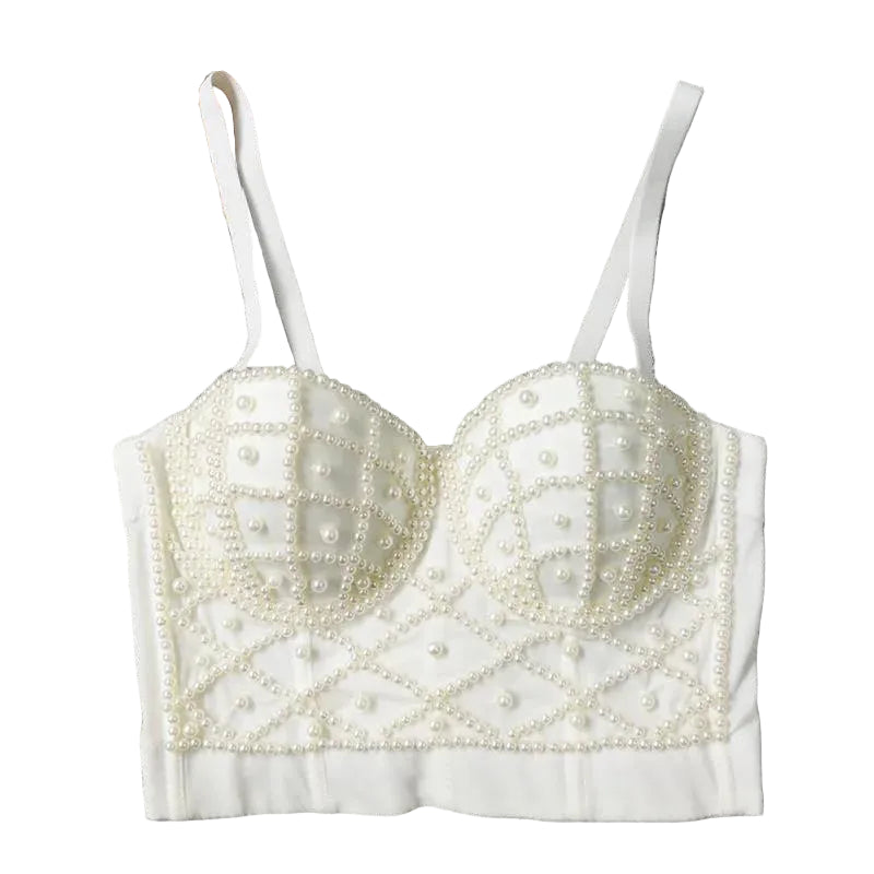 White beaded bralette on a textured gray surface