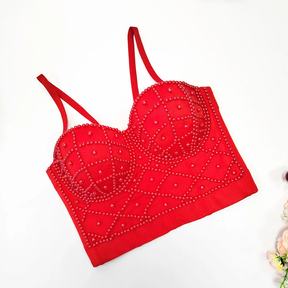 Red bralette with gemstone embellishments on a white background