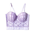 Lavender bralette with bead detailing on a gray background