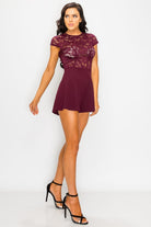 Stylish sheer lace combo romper in burgundy with a fitted lace top and flared shorts for a chic look