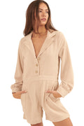 Beige corduroy romper for vacation featuring a collared neckline and button front with pockets