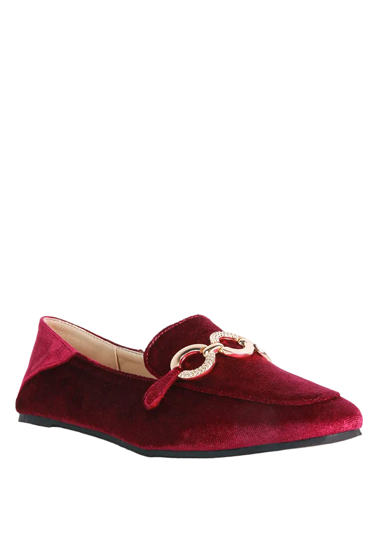 Red velvet loafer with a gold chain detail on a white background