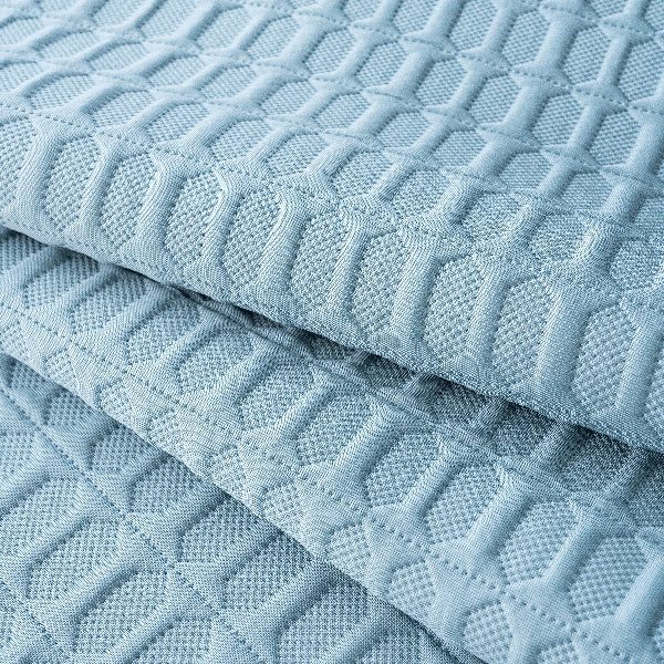 Light blue quilted fabric with a diamond pattern