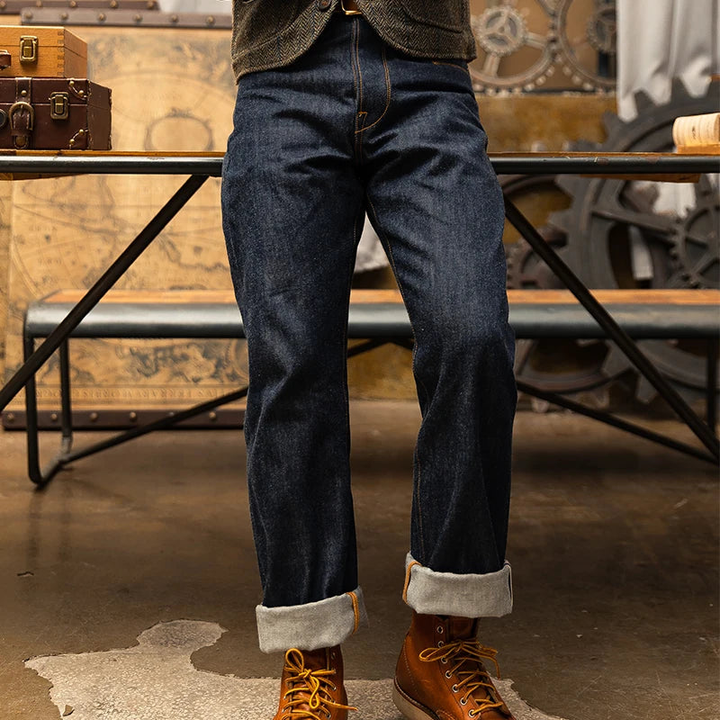 Person wearing dark blue jeans and brown boots in a vintage-style setting with suitcases and mechanical elements.