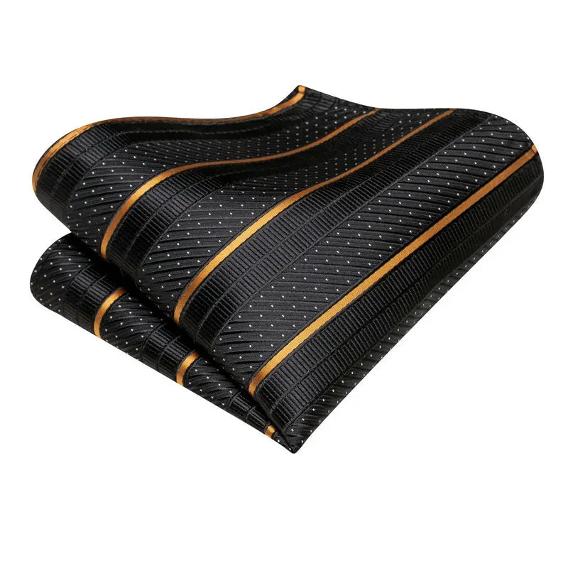 Black pocket square with gold accents, ideal for learning how fold a pocket square
