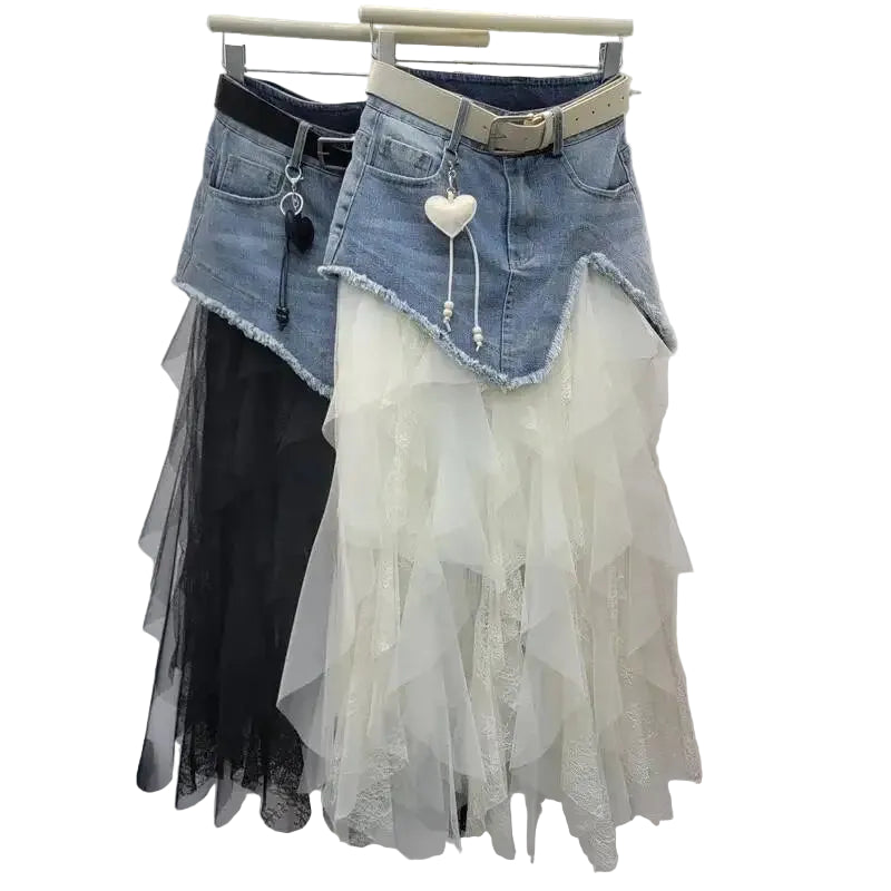 Denim skirt with lace overlay on a hanger against a white wall.