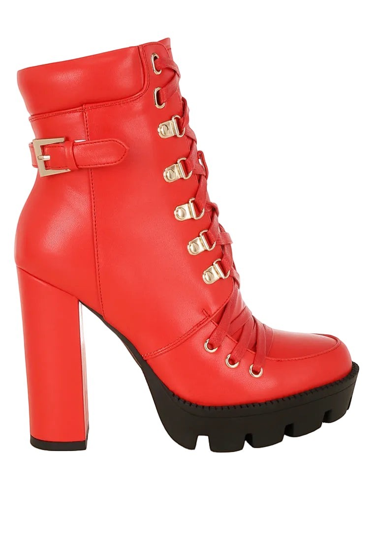 Red high-heeled platform boot with gold buckles on a white background