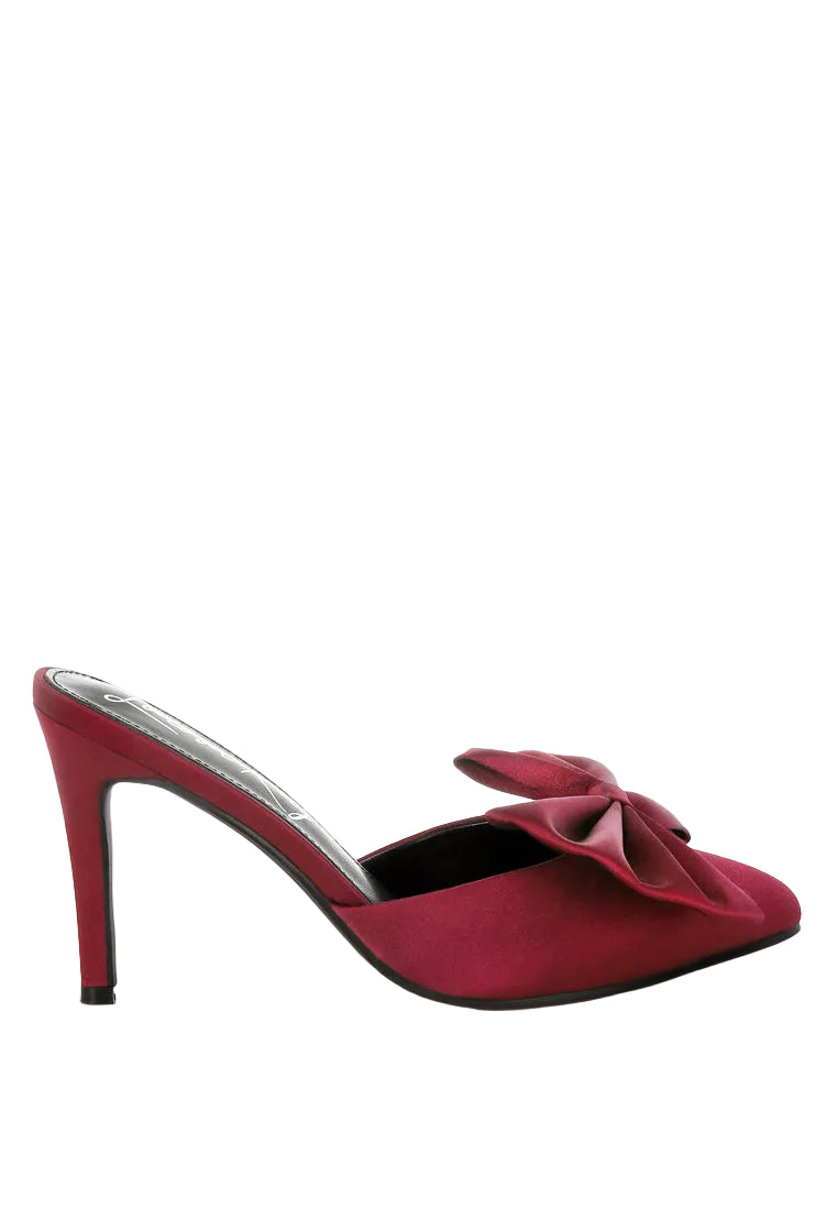 Red high-heeled shoe with a bow on a white background