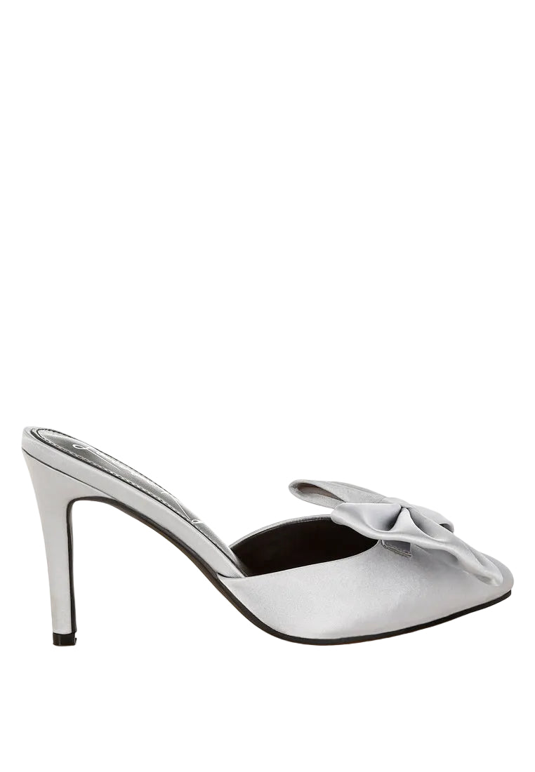 Silver high-heeled shoe with a bow on a white background