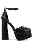 Black platform high-heeled shoe with crocodile texture on a white background