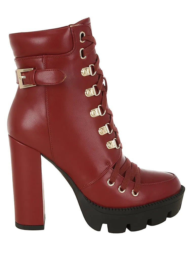 Red high-heeled boot with gold buckles on a white background