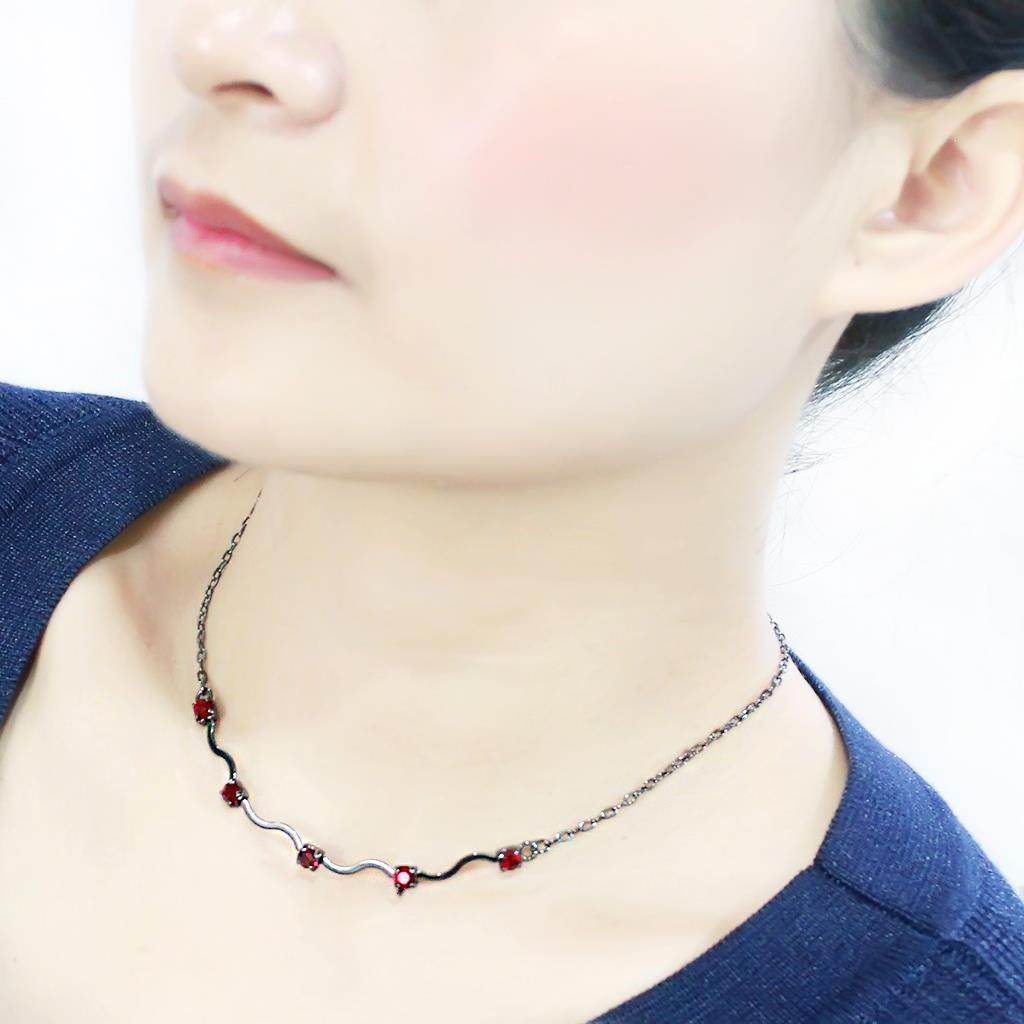 Stylish woman's neck showcasing an AAA grade CZ necklace with red gemstones on a delicate chain