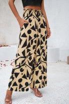 VacationGrabs women's allover print vacation pants with black geometric patterns on beige fabric