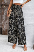 VacationGrabs women's allover print vacation pants in black and white with wide leg and elastic waistband