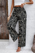 Women's allover print vacation pants in black and beige with a relaxed wide-leg fit by VacationGrabs