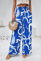 VacationGrabs women's blue allover print vacation pants with white abstract design and wide legs