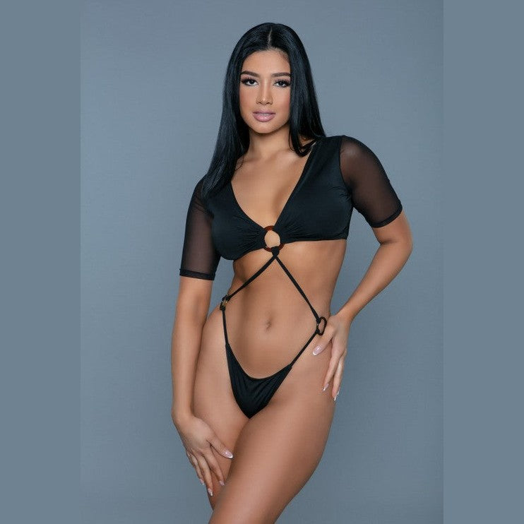 BE WICKED sexy black cutout swimsuit on model with mesh short sleeves ring front and strappy high cut bottoms