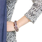 Elegant amethyst gemstone bangle bracelet showcased on a woman's wrist, perfect for any occasion