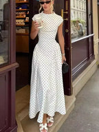 Women's white polka dot maxi dress, perfect for summer outings.