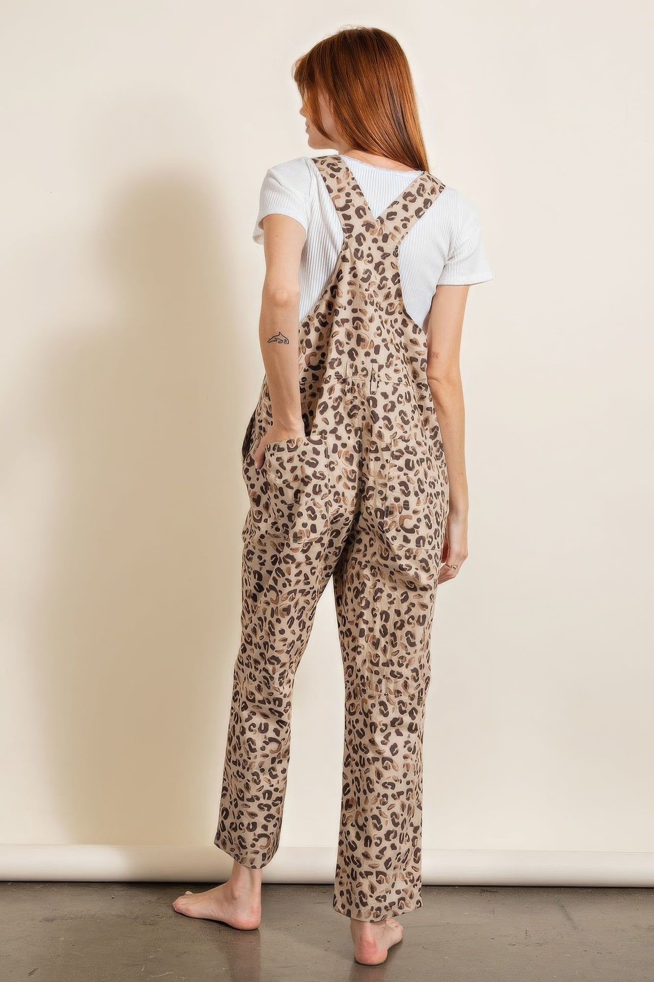 Animal print vacation outfit featuring a stylish women's jumpsuit with adjustable straps and pockets