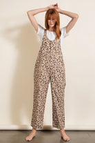 Trendy women's animal print vacation outfit featuring a stylish leopard print jumpsuit with adjustable straps