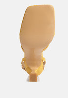 Bottom view of yellow London Rag International ankle strap spool heel sandals with textured design