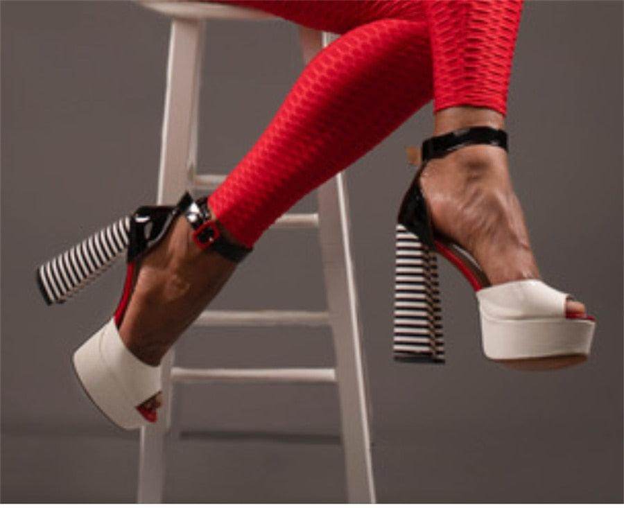 Stylish women's ankle strap square heel shoes in black and white with a bold striped design