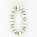 Antique silver women's bracelet featuring green and white pearls with decorative beads
