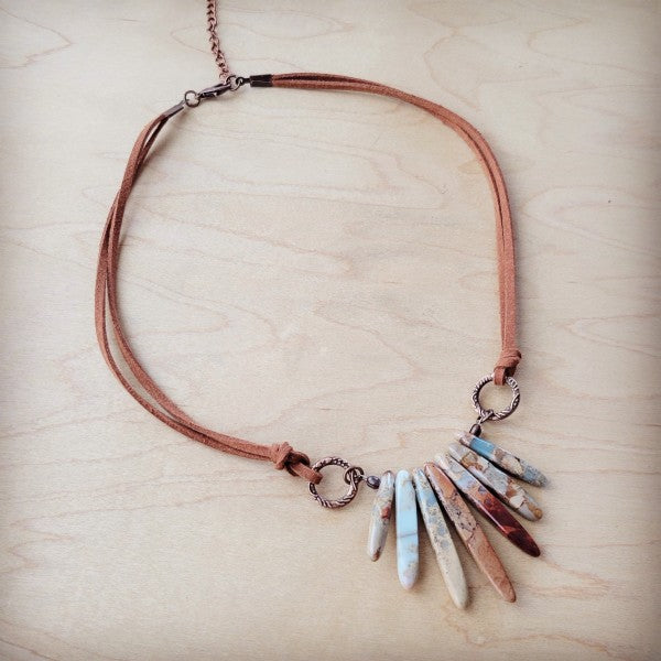 Aqua Terra leather necklace featuring colorful stone spikes on a brown leather cord