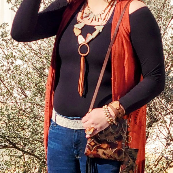 Stylish woman wearing an Aqua Terra leather necklace paired with a chic outfit and accessories