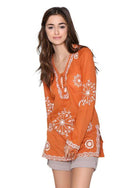 Qwasabee Aztec long sleeve top in orange with intricate white embroidery for a stylish look