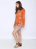 Qwasabee Aztec long sleeve top in orange with decorative patterns for a stylish bohemian look