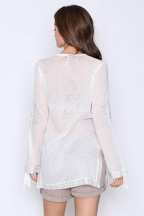 Back view of Qwasabee Aztec long sleeve top featuring intricate embroidery and a loose fit