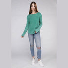 Female model wearing a ZENANA baby waffle knit shirt in green paired with distressed jeans