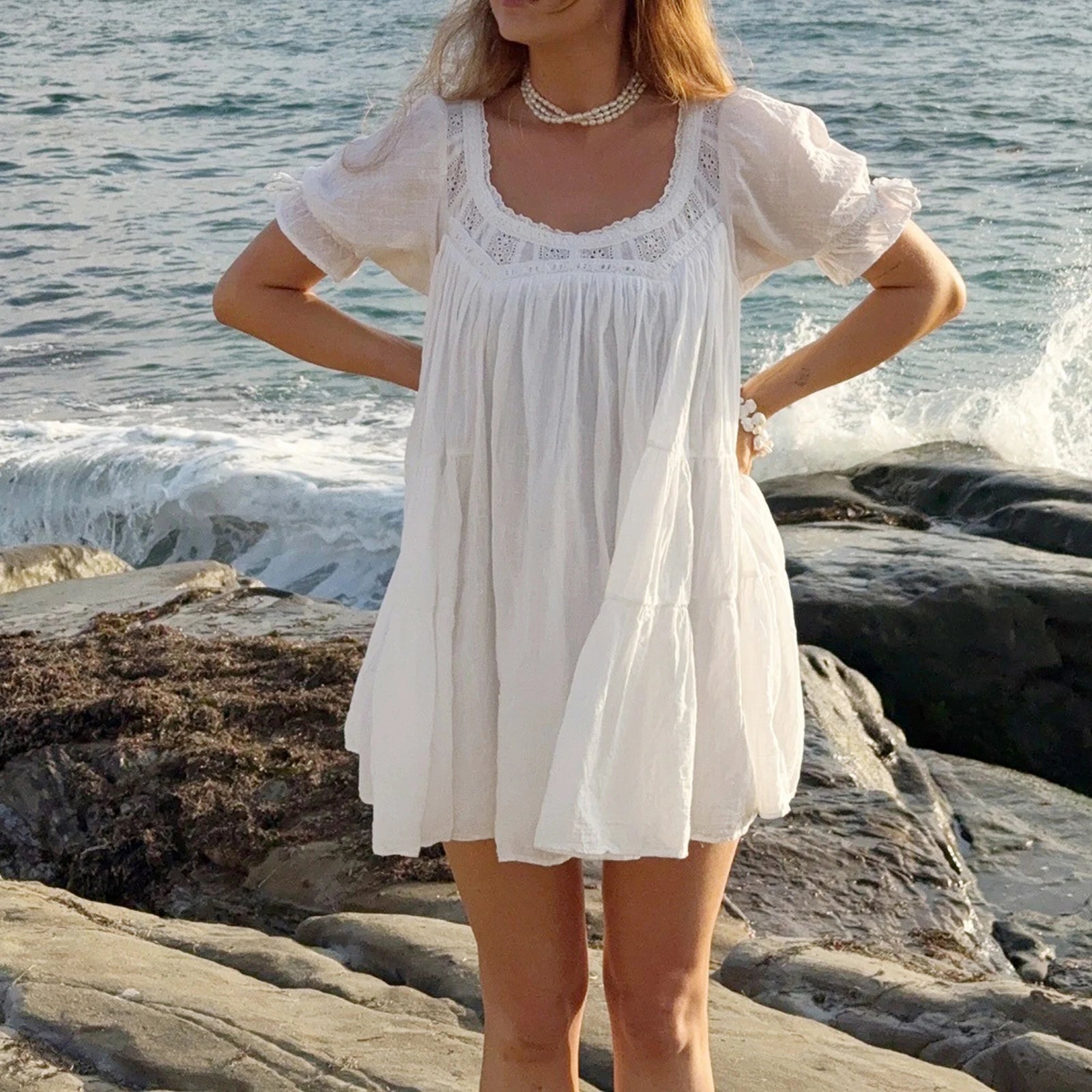 Women's white babydoll dress, lightweight fabric, perfect for beach outings
