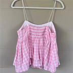 Pink gingham babydoll top with adjustable straps for summer outings