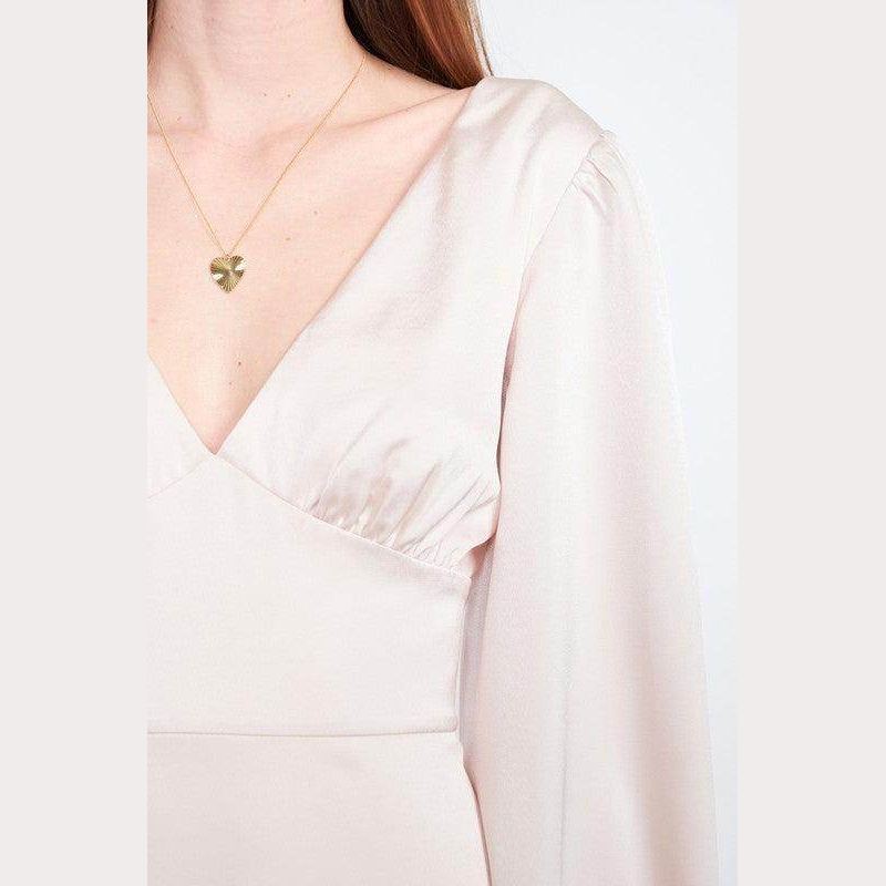 Close-up of a Women's back strap tulip mini dress by Emory Park, featuring a v-neck and long sleeves