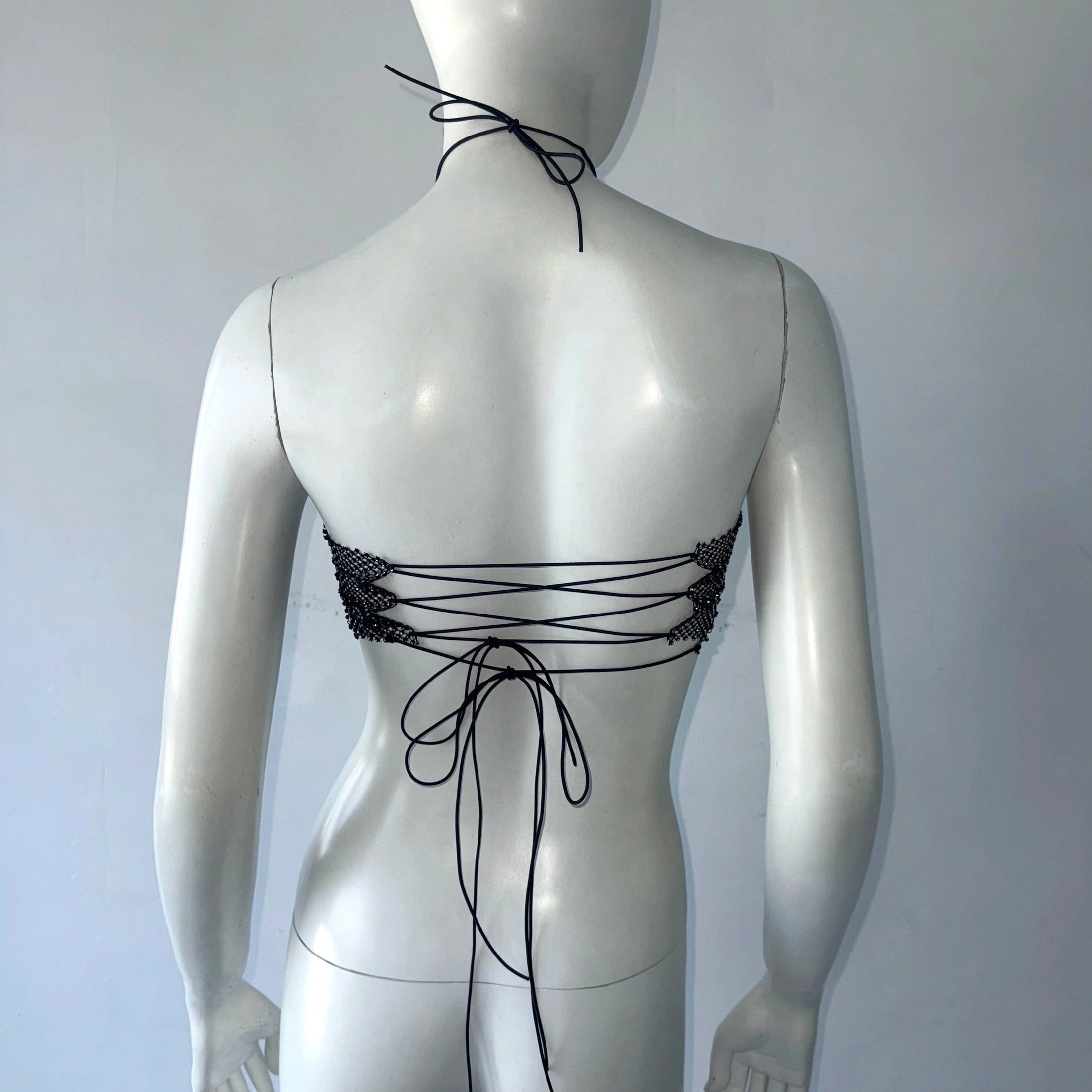 Black backless bandage clubwear tank with lace-up tie detail on mannequin back