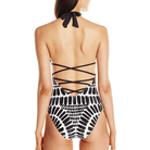 Stylish backless one-piece swimsuit in black and white with crisscross straps for elegant beachwear