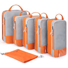 Orange compression packing cubes for travel in various sizes