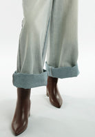 Stylish women's metallic accent ankle boots paired with rolled hem jeans for a chic look
