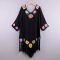 Black cover up for the beach with colorful floral accents and fringe
