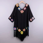 Black cover up for the beach with colorful floral accents and fringe