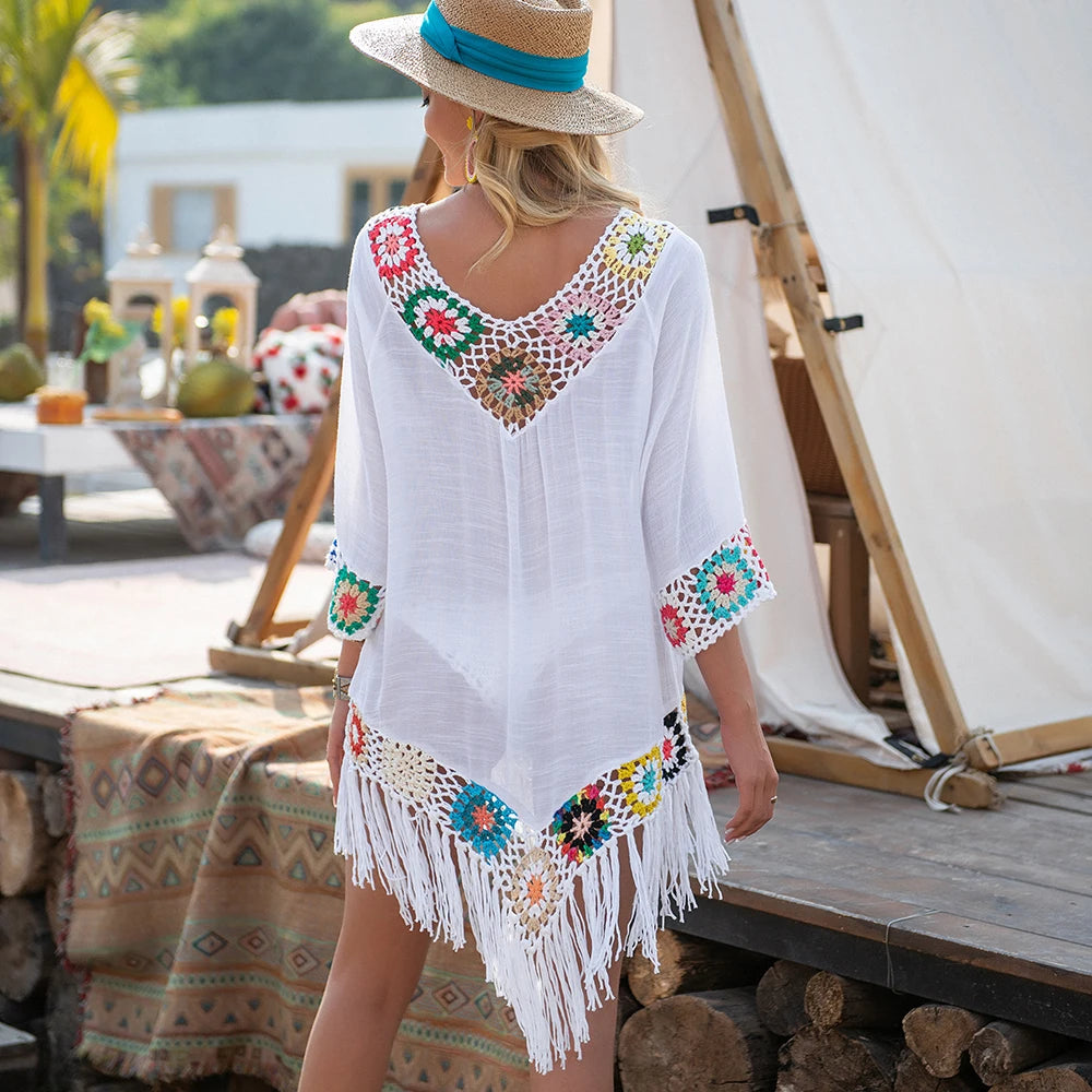 White crochet cover up for the beach with colorful details and fringe