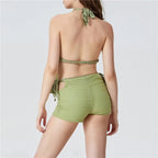 Women's green beachwear bathing suits with open back and high-waisted shorts