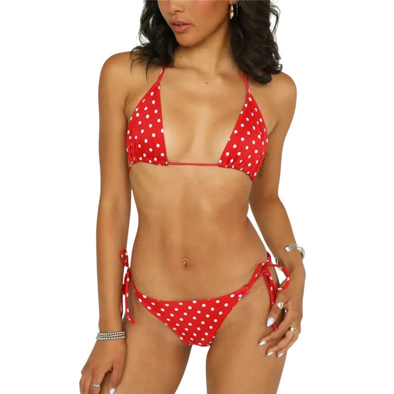 Woman wearing a red polka dot bikini on a white background