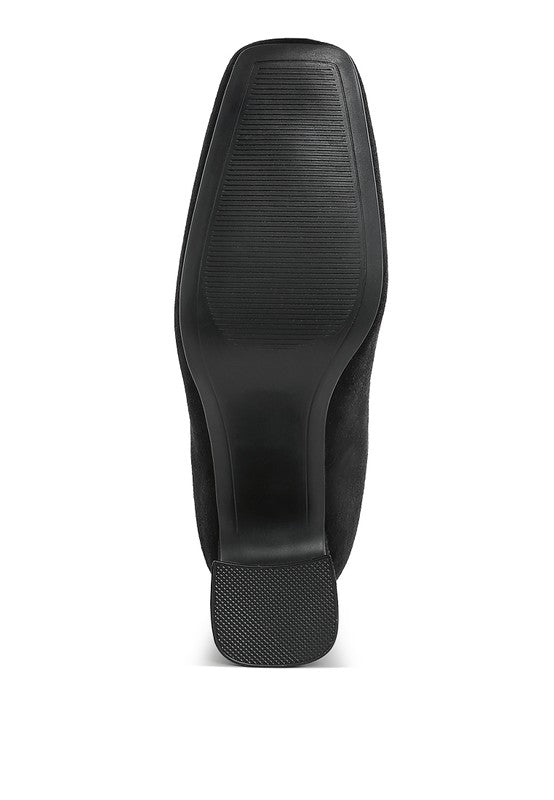 Bottom view of beige square toe heeled booties showcasing the textured sole for better traction