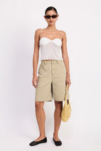 Model wearing Emory Park sheer mesh floral cami top in white with khaki bermuda shorts and yellow bag
